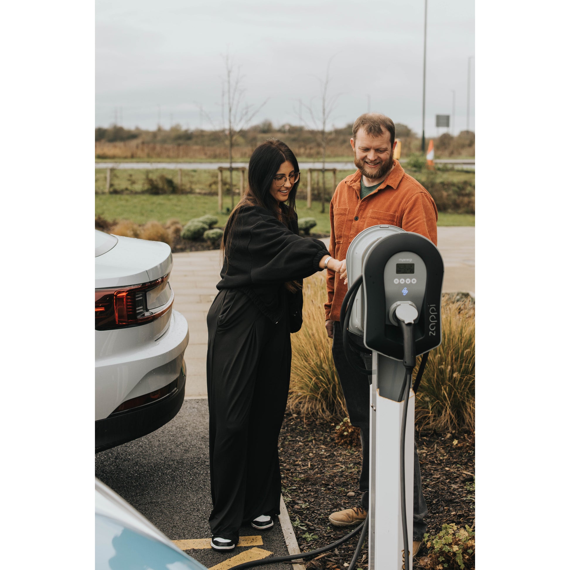 zappi Tethered EV Charger in Black - two people using