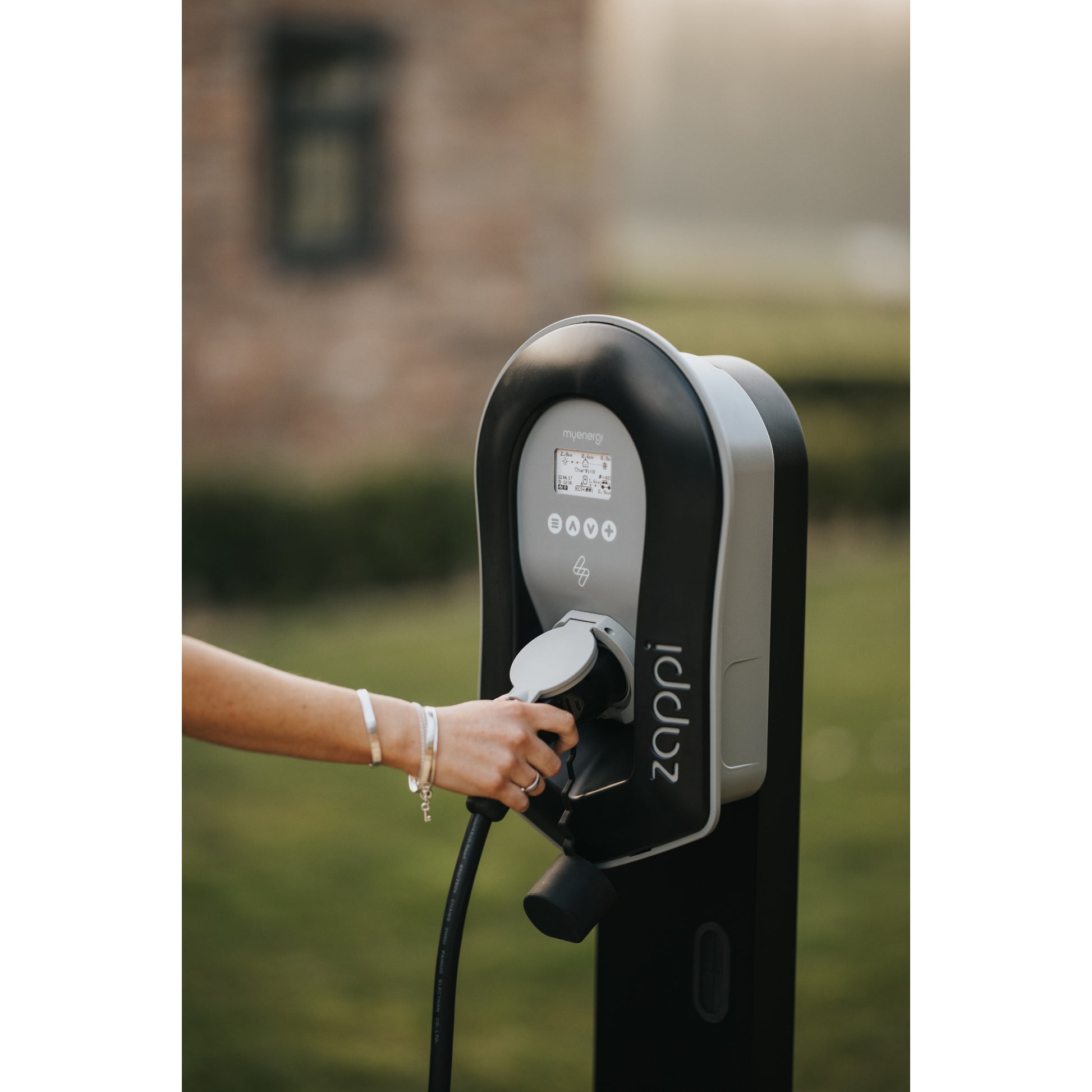 zappi Tethered EV Charger in Black - hand on cable