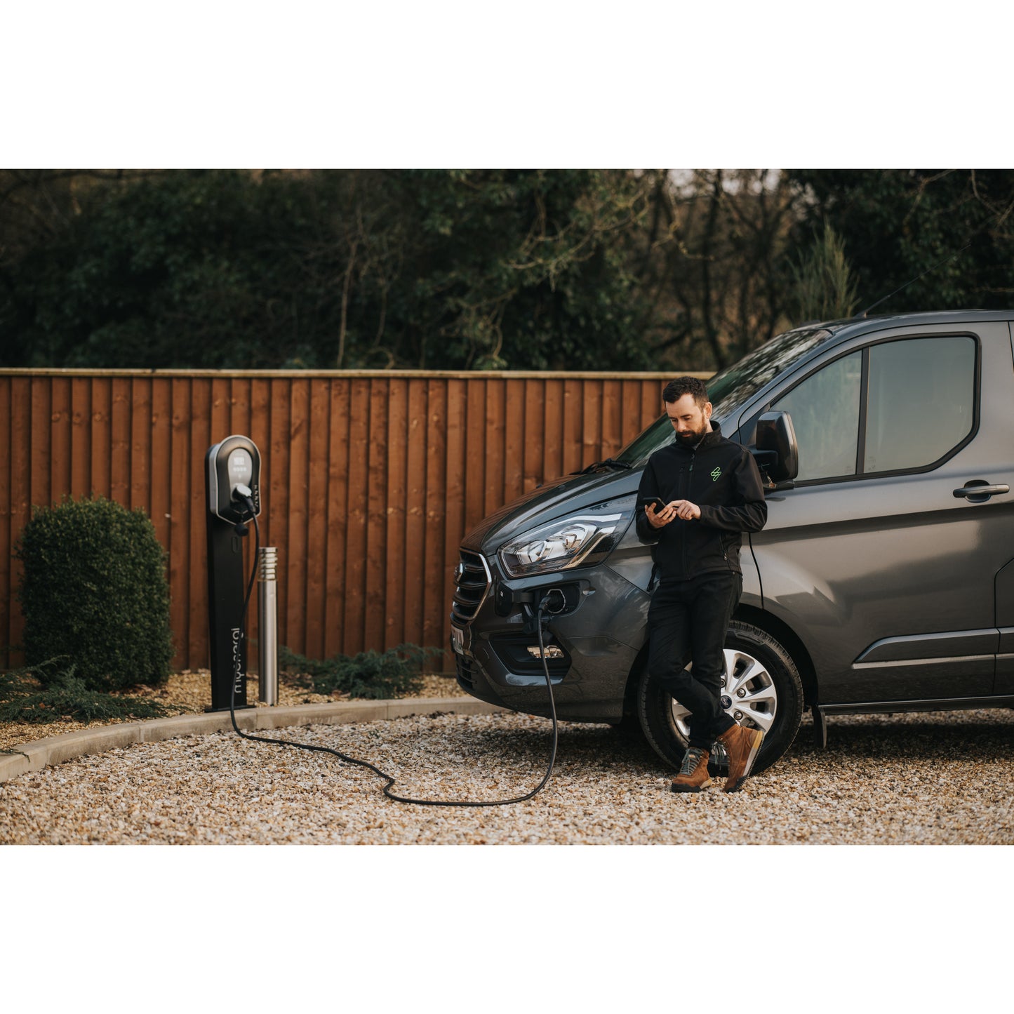 zappi Tethered EV Charger in Black - man using app